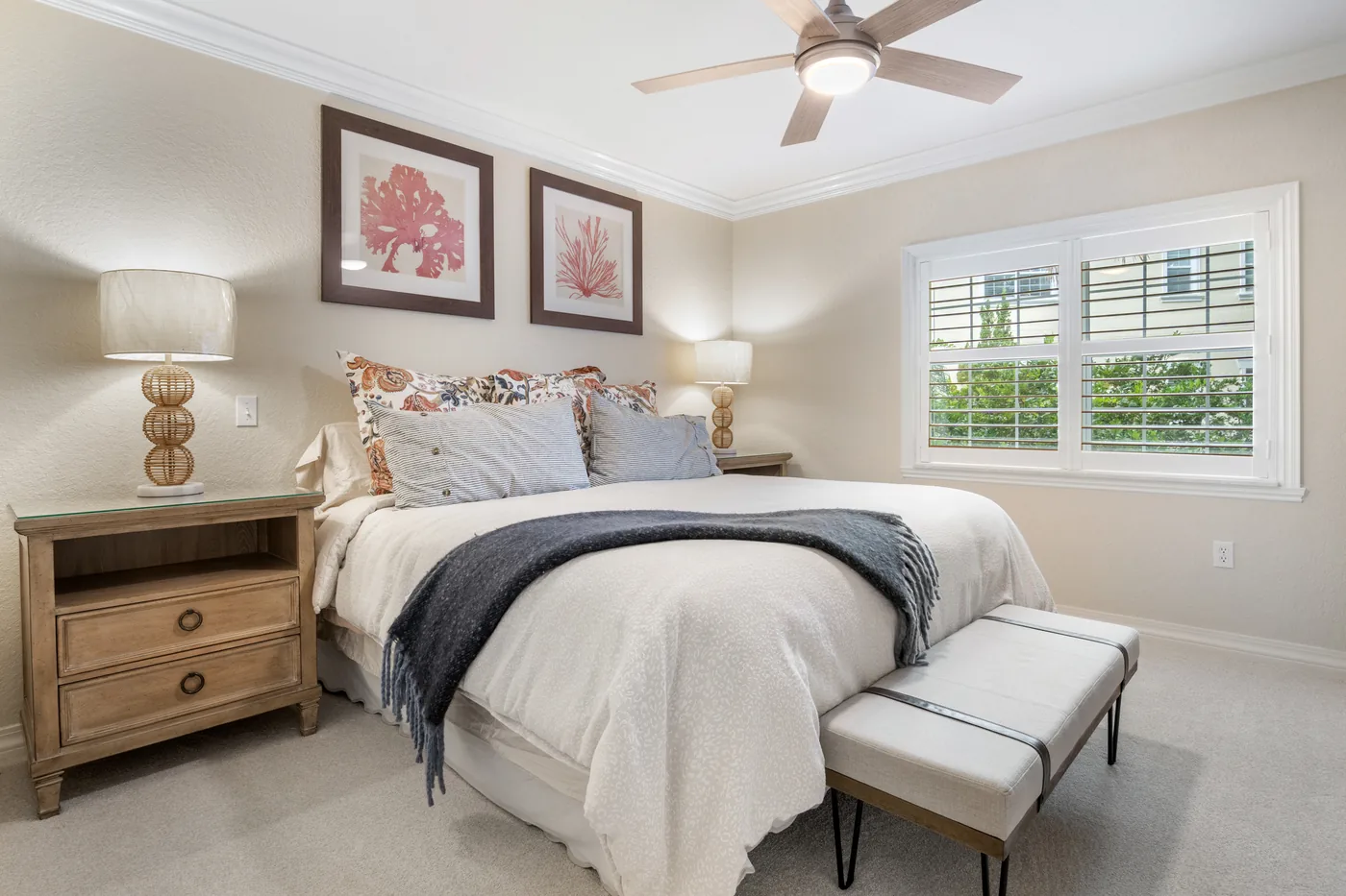 Primary bedroom real estate photography with plantation shutters and coastal decor - professional listing photo by REMIX, Winter Garden FL