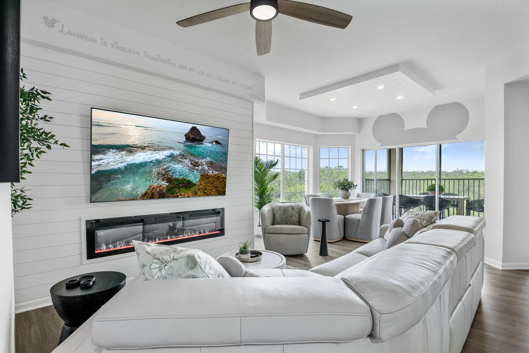 Open concept living room with electric fireplace and pool view - professional real estate interior photography by REMIX, Horizon West Florida