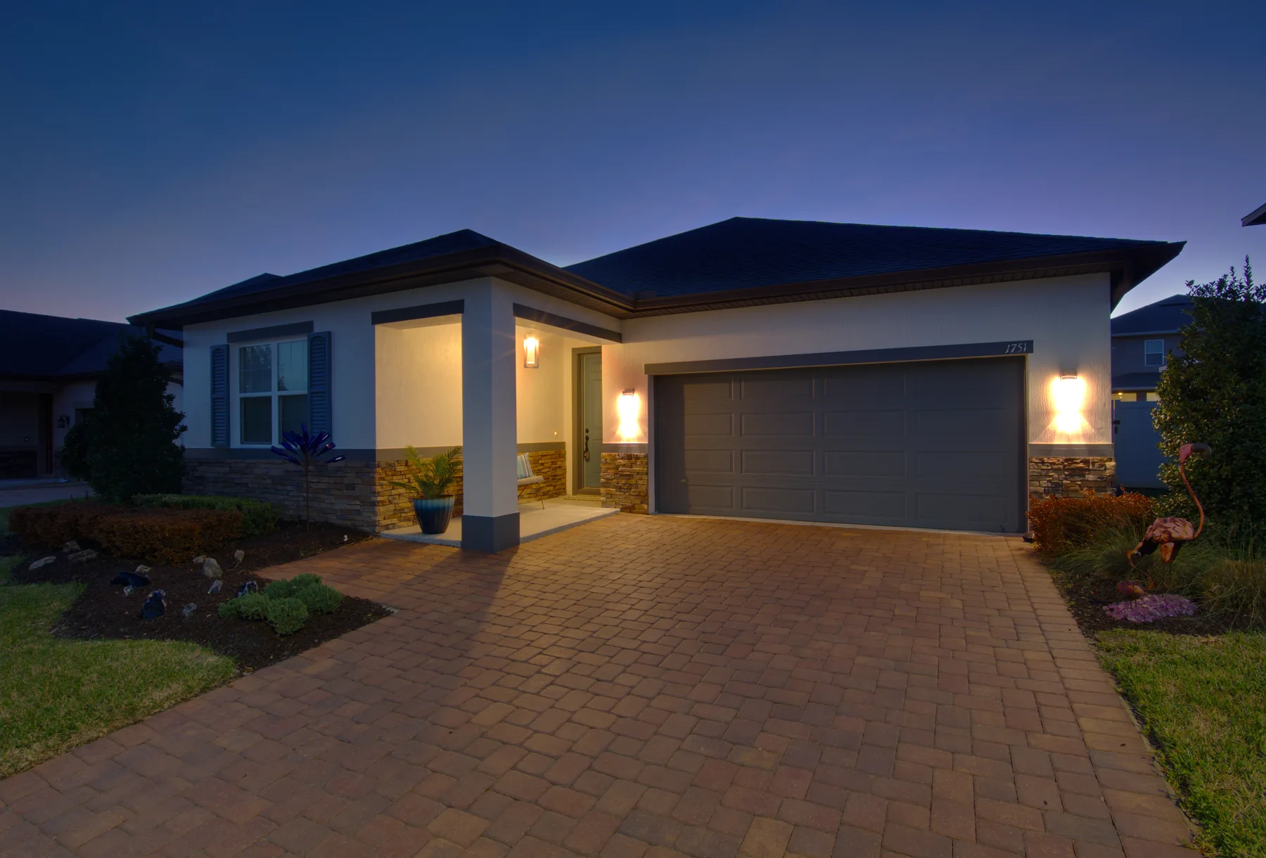 Twilight real estate photography at dusk - Florida home with warm exterior lighting by REMIX, Central Florida listing photographer